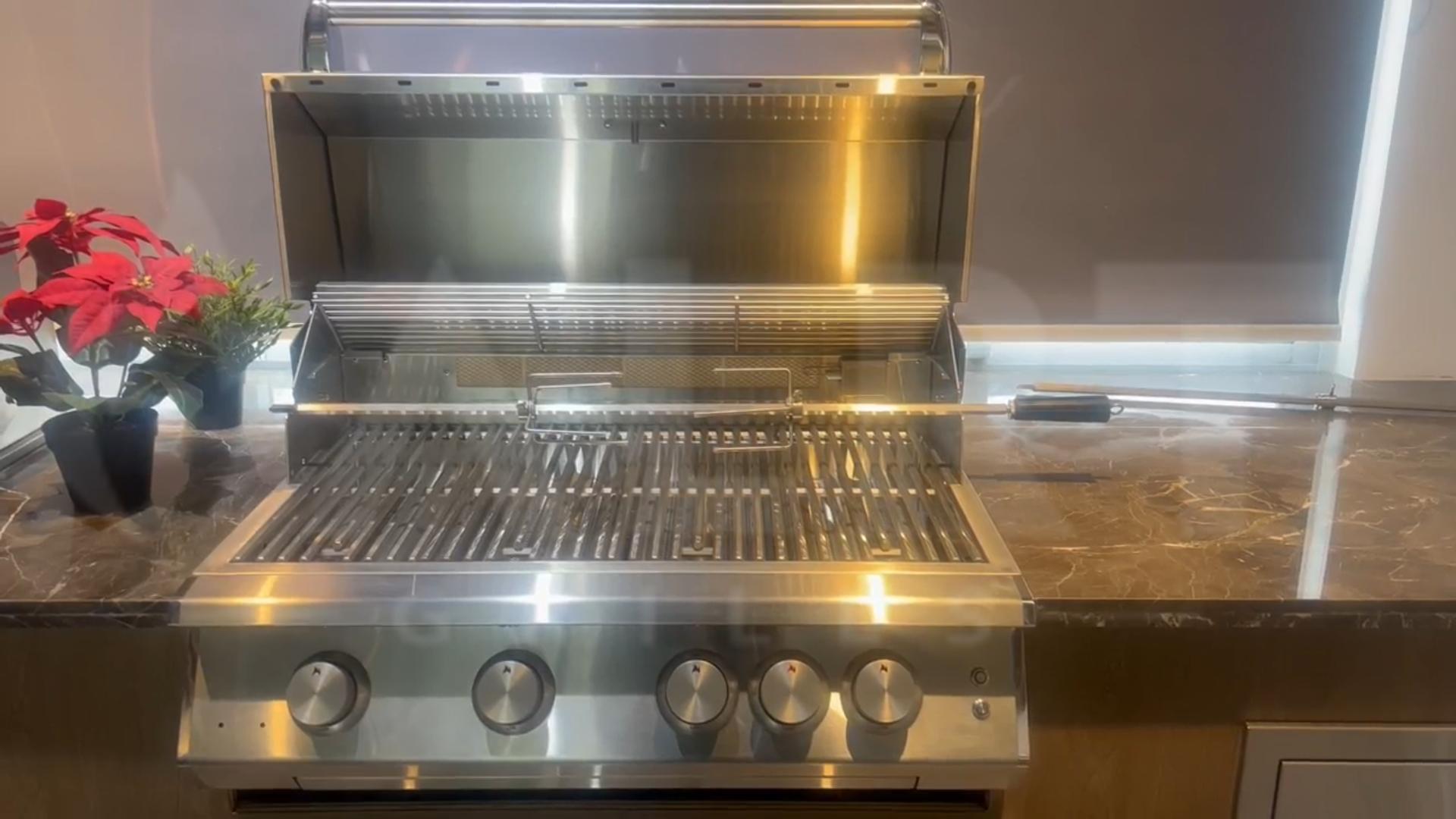 Professional 32-inch 4-burner built-in gas grill equipped with a rear infrared burner, rotisserie kit, and mirror-finish cooking grates.